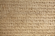 Ancient greek writing on stone background